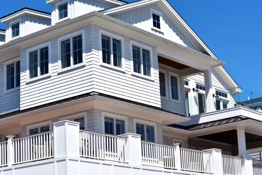 White shingle-sided beach house with white seamless gutters and vinyl deck railing in Ventnor, NJ