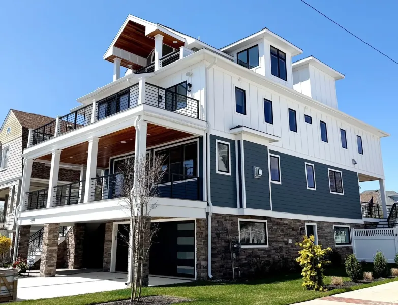 Large navy and white coastal home with white seamless gutters and downspouts in Ventnor, NJ