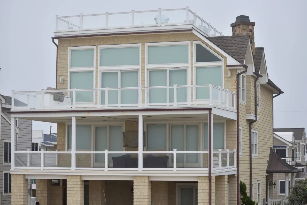 Bronze seamless gutters along the decks of a multi-level shingle beach house in Haddonfield, NJ